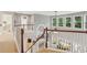 Upstairs foyer overlooking the downstairs living area with hardwood banisters at 927 Ivey Chase Pl, Dacula, GA 30019