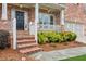 Charming front porch with brick steps and manicured landscaping, leading to the front door at 927 Ivey Chase Pl, Dacula, GA 30019
