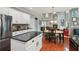 Open kitchen with center island, black counters, and view to the living room fireplace at 927 Ivey Chase Pl, Dacula, GA 30019