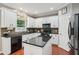 Well-lit kitchen with white cabinets, black appliances, and granite countertops at 927 Ivey Chase Pl, Dacula, GA 30019