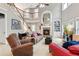Spacious living room with soaring ceilings, fireplace, and staircase to second level at 927 Ivey Chase Pl, Dacula, GA 30019