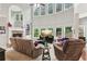 Inviting living room with stone fireplace, built-in shelves, and large windows at 927 Ivey Chase Pl, Dacula, GA 30019