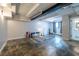 Spacious open basement featuring concrete flooring, a window, and an open-concept with an entrance to a bathroom at 240 Patterson Se Ave, Atlanta, GA 30316