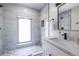 Modern bathroom featuring updated tile, river rock flooring, and a glass shower with a large window at 240 Patterson Se Ave, Atlanta, GA 30316