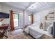 Cozy bedroom with modern decor, wood floors, desk, and plenty of natural light from the windows at 240 Patterson Se Ave, Atlanta, GA 30316