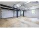 Open concept garage featuring two bay doors, exposed beams, and large windows for natural light at 240 Patterson Se Ave, Atlanta, GA 30316