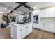 Bright kitchen with white cabinetry, central island, and stainless steel appliances, open to the living room at 240 Patterson Se Ave, Atlanta, GA 30316