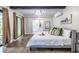 Bright bedroom with wood floors, ensuite bathroom, balcony access, and minimalist decor at 240 Patterson Se Ave, Atlanta, GA 30316