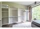 Spacious walk-in closet with an adjustable shelving system and natural light from the window at 240 Patterson Se Ave, Atlanta, GA 30316