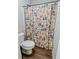 Bathroom featuring a toilet next to a floral patterned shower curtain at 2980 Hd Atha Rd, Covington, GA 30014
