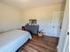 Bedroom featuring wood floors, grey dresser, and closet at 2980 Hd Atha Rd, Covington, GA 30014