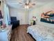 Bedroom with hardwood floors, ceiling fan, dresser, and desk workstation at 2980 Hd Atha Rd, Covington, GA 30014