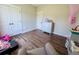 Bedroom featuring wood floors, white trim, closet, and dresser at 2980 Hd Atha Rd, Covington, GA 30014
