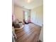 Bright bedroom with wood floors, glider chair, and natural light at 2980 Hd Atha Rd, Covington, GA 30014