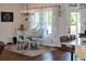 Cozy dining room featuring a table with six chairs, a chandelier, and large windows with decorative curtains at 2980 Hd Atha Rd, Covington, GA 30014