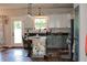 Bright kitchen showcases an island with bar stools, modern appliances, and an abundance of natural light at 2980 Hd Atha Rd, Covington, GA 30014