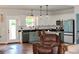 Charming kitchen featuring an island with bar seating and stainless steel appliances in an open-concept layout at 2980 Hd Atha Rd, Covington, GA 30014