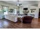 Spacious living room with modern decor, a fireplace, ceiling fan, and hardwood floors at 2980 Hd Atha Rd, Covington, GA 30014