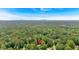 Secluded home nestled amongst dense trees and a clear blue sky at 40 Picketts Forge W Dr, Acworth, GA 30101