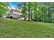 Expansive backyard with a well-maintained lawn, trees, and a charming two-story home in a desirable location at 40 Picketts Forge W Dr, Acworth, GA 30101