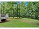 Expansive backyard with mature trees and a partially visible deck, perfect for outdoor activities at 40 Picketts Forge W Dr, Acworth, GA 30101