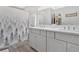 Modern bathroom boasts double vanity, grey cabinets, and quartz countertop at 40 Picketts Forge W Dr, Acworth, GA 30101