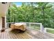 Spacious wooden deck with white railings, ideal for outdoor dining and relaxation surrounded by lush greenery at 40 Picketts Forge W Dr, Acworth, GA 30101