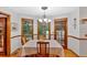Cozy dining area featuring wood trim, hardwood floors, and natural light from the large windows at 40 Picketts Forge W Dr, Acworth, GA 30101