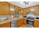 Bright kitchen featuring wood cabinets, stainless steel appliances, and ample countertop space at 40 Picketts Forge W Dr, Acworth, GA 30101