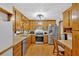 Well-lit kitchen with wood cabinets, stainless steel appliances, and a unique textured ceiling at 40 Picketts Forge W Dr, Acworth, GA 30101