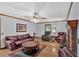 Cozy living room with a brick fireplace, hardwood floors, and comfortable leather furniture at 40 Picketts Forge W Dr, Acworth, GA 30101