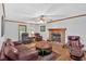Inviting living room featuring a brick fireplace, hardwood floors, and leather seating at 40 Picketts Forge W Dr, Acworth, GA 30101