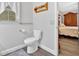 Cozy half bath features grey vinyl floors and convenient access to the bedroom at 40 Picketts Forge W Dr, Acworth, GA 30101