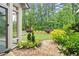 Beautiful backyard featuring lush greenery, a well-manicured lawn, and a charming rock garden, creating a serene outdoor space at 4137 Avid Park, Marietta, GA 30062