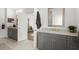 Bright bathroom features double vanity, gray cabinets, granite countertop, and tile floor at 4137 Avid Park, Marietta, GA 30062
