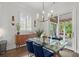 Dining room with a glass top table, blue velvet chairs, and sliding doors to outdoor area at 4137 Avid Park, Marietta, GA 30062