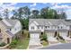 Three-story townhomes with neutral siding, brick accents, and two-car garages, surrounded by well-manicured landscaping at 4137 Avid Park, Marietta, GA 30062