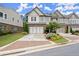Charming two-story townhome featuring a brick facade, two-car garage, and beautifully landscaped front yard at 4137 Avid Park, Marietta, GA 30062