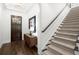 Bright foyer with hardwood floors, staircase, and a stylish console table under a framed art piece at 4137 Avid Park, Marietta, GA 30062