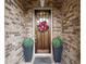 Inviting front door with a wreath, flanked by potted plants, set in a brick surround at 4137 Avid Park, Marietta, GA 30062