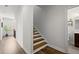 Hallway with wood floors, staircase, and doorway leading to the bathroom at 4137 Avid Park, Marietta, GA 30062