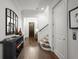 Bright hallway with hardwood floors, leading to staircase and front door, with stylish decor at 4137 Avid Park, Marietta, GA 30062