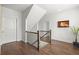 Upstairs hallway with hardwood floors, wooden railing, and a view of the staircase at 4137 Avid Park, Marietta, GA 30062
