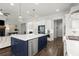 Open floorplan kitchen with island, seating, stainless appliances, white cabinets, and hardwood floors at 4137 Avid Park, Marietta, GA 30062