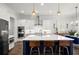 Modern kitchen featuring white cabinets, blue island, stainless steel appliances and hardwood floors at 4137 Avid Park, Marietta, GA 30062