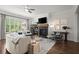 Bright living room featuring a fireplace, comfortable seating, and large windows for natural light at 4137 Avid Park, Marietta, GA 30062