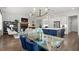 Open living and dining area with hardwood floors, a fireplace, and a view into the modern kitchen at 4137 Avid Park, Marietta, GA 30062