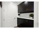Mudroom with custom black cabinets, white countertops, and gold hardware offers stylish storage solutions at 4137 Avid Park, Marietta, GA 30062