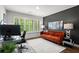 Modern office area featuring a bright orange sofa, a work space, and lots of natural light at 4137 Avid Park, Marietta, GA 30062