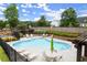 Community pool area featuring a kidney-shaped pool, lounge chairs, tables with umbrellas, and a covered seating area for residents at 4137 Avid Park, Marietta, GA 30062